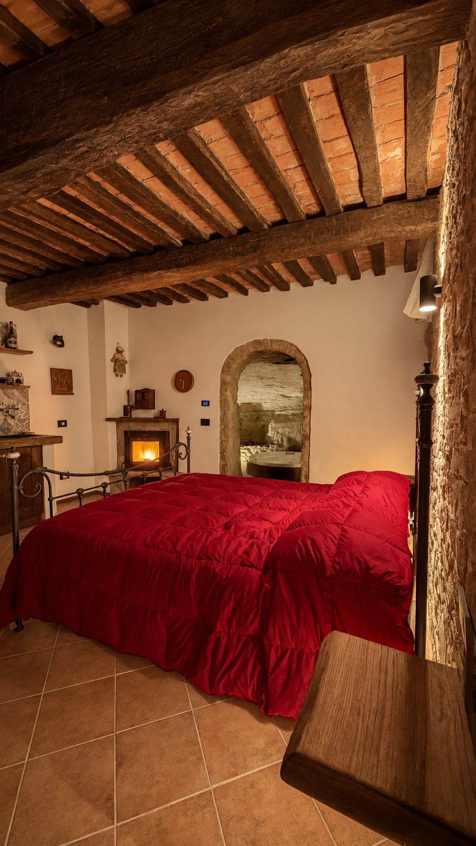 Sleeping area with kitchen, fireplace and arch leading to the cave
